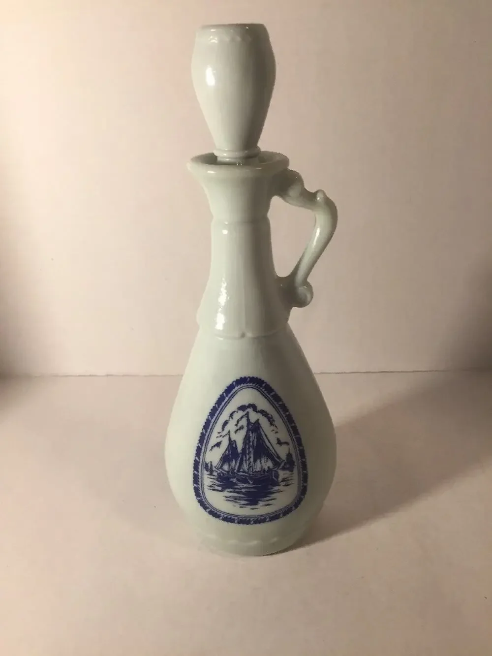Vintage 1963 Jim Beam white milkglass decanter with blue ships and windmill. 13